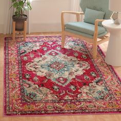 a living room with a chair, rug and potted plant