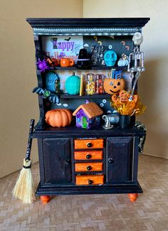 an old fashioned halloween cabinet with decorations on it