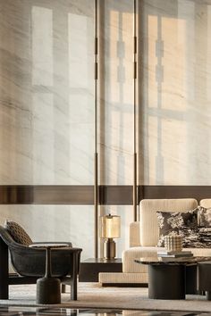 a living room filled with furniture next to a tall window covered in sheered curtains