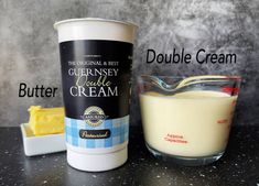 a cup of cream next to a container of butter