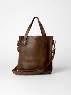 The Tote Bag in vintage brown leather by John Woodbridge in small format 35 x 32 cm with long straps to be worn on the shoulder. - Dimensions : 35 x 32 cm - 2 inside pockets - Available in 1 color vintage brown On-the-go Satchel Shoulder Bag With Brass Hardware, Classic Brown Bucket Bag For On-the-go, Classic Brown Bucket Bag With Double Handle, Classic Brown Shoulder Bag For On-the-go, Vintage Brown Bag For Everyday Use, Classic Bags With Brass Hardware For On-the-go, Vintage Brown Double Handle Shoulder Bag For Daily Use, Brown Business Bucket Bag With Double Handle, Vintage Brown Bag With Adjustable Strap For Everyday