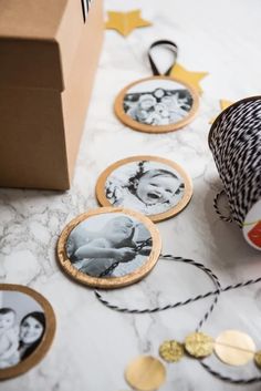 a table topped with pictures and twine spools next to a brown box