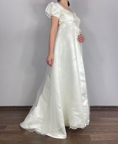 Regency style wedding dress Made of beautiful satin and organza, adorned with hand embroidered lace embellished with beads and pearls, fully captures the ambiance of that era.  Size:38 Bust 94 cm  Under bust 86 cm  Front length 140 cm  Back length 170 cm Material: Polyester satin, organza Formal Satin Gown With Detachable Train, Elegant Satin Ball Gown With Detachable Train, Organza Ball Gown With Sweep Train And Fitted Bodice, Organza Evening Dress With Sweep Train For Debutante Ball, Elegant Floor-length Ball Gown With Lace Bodice, Elegant Cream Tulle Gown, Satin Ball Gown With Detachable Train, Lace Evening Dress For Debutante Ball, Satin Wedding Dress With Sweep Train