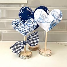 three heart shaped napkins on top of wooden sticks