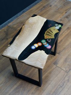 a wooden bench with buttons on it sitting on top of a hard wood floor next to a wall