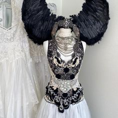 a white dress with black wings on it