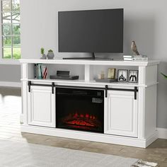 a white entertainment center with an electric fireplace