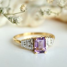 "1.08 Ct emerald cut natural Amethyst gemstone, with baguette and princess cut natural diamonds, this art deco inspired ring is all the rage! It makes for a gorgeous engagement ring and a family heirloom.. :) A perfect piece of birthstone jewelry to own for the February born ladies! * Center Gemstones : Natural Amethyst * Stone Shape : Emerald Cut * Stone Wt. : 0.1.08 ct * Accent Gemstone : Natural Diamonds * Diamond Wt. : 0.26 Cts * Color-Clarity Grade : H-I, Vs-Si * Gold - 14k, 2.81 gms gold ( Amethyst Baguette Ring, Elegant Purple Amethyst Baguette Cut Ring, Elegant Purple Baguette Cut Amethyst Ring, Classic Amethyst Diamond Ring With Emerald Cut, Art Deco Diamond Ring With Baguette Cut Gemstone, Classic Rectangular Amethyst Ring For Anniversary, Classic Amethyst Rectangular Ring For Anniversary, Elegant Baguette-cut Amethyst Ring For Anniversary, Elegant Amethyst Baguette Cut Ring For Anniversary