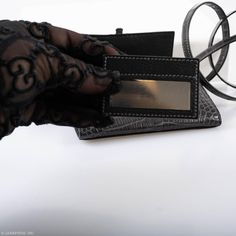 The Cinhetic design, which draws inspiration from moving Kinetic art, is rendered here as a square wallet surrounding an ingenious closure. When locked, the clasp resembles an H for Hermes, but when open, the pieces rotate into a sleek metal line. This extraordinary example is done in Matte Graphite Alligator with Palladium hardware, and features the super useful removable matching Alligator shoulder strap, and a small leather-bound mirror which fits perfectly into one of the wallet’s interior s Luxury Rfid Blocking Card Holder As Gift, Leather Bifold Card Holder For Evening, Luxury Rectangular Wallets For Gift, Luxury Rectangular Wallets For Gifts, Formal Compact Leather Card Holder, Elegant Wallets With Interior Card Slots, Elegant Rectangular Wallet With Interior Card Slots, Luxury Formal Wallet With Crocodile Pattern, Formal Crocodile Pattern Rectangular Card Holder