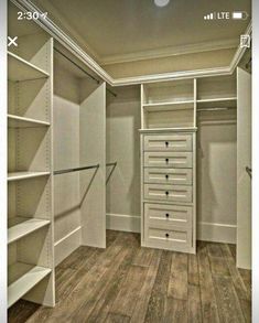 an empty walk in closet with shelves and drawers