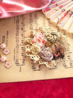 a close up of a flower on top of an old book with music notes in the background