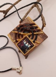 8525. Jewelry gemstone eudialyte wood micro-mosaic jewellry wooden mosaic handmade pendant by Aleksei Volchkov Instagram Aleksis_wolf13 The design of this jewelry was developed specifically for Etsy by artist Aleksei Volchkov The  is made of 3D wooden micro-mosaic. The geometric lines of this jewelry are fully consistent with the classic Art Deco style ornament. The lines of the design are made using a unique 3D wooden micro-mosaic. This jewelry was made by me in January 2024. An absolutely uniq Artisan Wood Jewelry Gift, Artisan Wooden Jewelry As A Gift, Handmade Wooden Pendant Jewelry, Unique Brown Jewelry With Inlay, Unique Inlay Necklace As Gift, Unique Inlay Necklace For Gift, Spiritual Wood Jewelry For Gifts, Handmade Brown Square Pendant Jewelry, Wooden Mosaic