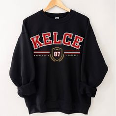 Perfect sweatshirt for anyone who is a Travis Kelce or Chiefs fan.  Ideal for any situation, a unisex heavy blend crewneck sweatshirt is pure comfort. These garments are made from polyester and cotton. This combination helps designs come out looking fresh and beautiful. The collar is ribbed knit, so it retains its shape even after washing. There are no itchy side seams on these sweaters.  .: 50% cotton, 50% polyester .: Medium-heavy fabric (8.0 oz/yd² (271.25 g/m .: Loose fit .: Sewn-in label .: Runs true to size ⭐️SWEATSHIRT & T-SHIRT INFORMATION: - DTG Printing Style for a vintage, weathered look. - DTG is engineered to last longer than traditional iron on printing. - This is NOT iron on or heat press printing style. - Light Fabric 🚐SHIPPING: - DOUBLE CHECK YOUR SHIPPING ADDRESS BEFORE Fan Gear Text Print Crew Neck Sweatshirt, Crew Neck Sweatshirt With Text Print For Fans, Fan Merchandise Text Print Crew Neck Sweatshirt, Heat Press Printing, Kansas City Football, Football Sweatshirt, Travis Kelce, Looks Vintage, Sew-in Labels