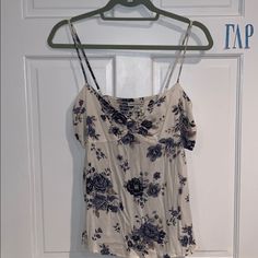 Never Worn, No Tags! Cut Out Sides Cotton Camisole Tops With Floral Print, Casual Camisole Tops For Vacation, Floral Print Cami Top For Day Out, Floral Print Cotton Cami Top, Cotton Floral Print Cami Tops, Blue Tank Top For Day Out, Blue Tank Top For A Day Out, Casual Cotton Camisole With Floral Print, Trendy Floral Print Camisole Top