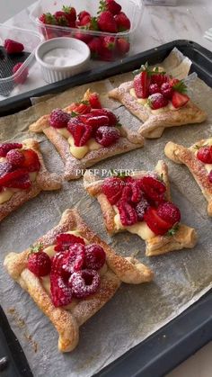 strawberry shortcakes with powdered sugar and fresh strawberries on top are ready to be eaten