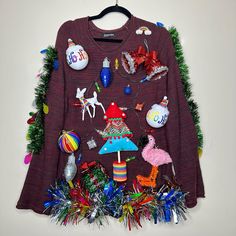 an ugly sweater hanging on a wall with christmas decorations and other things around the neck