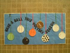 a bulletin board with sports balls hanging from it's sides and the words have a ball this holiday season