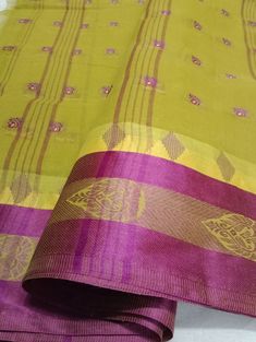 "Introducing our exquisite \"Cotton Confections: Green color with Purple Striped Handloom Saree.\" Handcrafted with love, this cotton saree showcases a delightful pink hue complemented by a charming border design adorned with vibrant green stripes. Experience the perfect blend of comfort and elegance in this lightweight creation, designed to enhance your style for any occasion. Immerse yourself in the timeless allure of this saree, fusing tradition with contemporary flair. Elevate your fashion statement with this captivating masterpiece, now available in green and purple shades." Handloom Cotton Saree, Purple Shades, Handloom Saree, Vibrant Green, Border Design, Green Stripes, Cotton Saree, Green Colors, Green Color