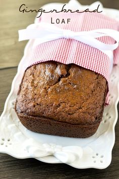 a close up of a loaf of bread on a plate with the words gingerbread loaf