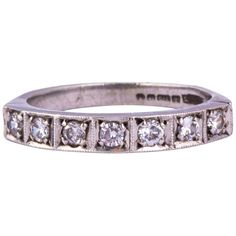 an antique diamond wedding ring with five stones on the side and four rows of diamonds in the middle