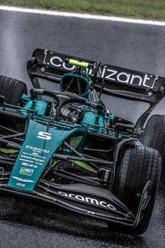 a racing car driving on a wet track