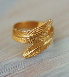 Gorgeous feather 14K Gold plated ring... available ONLY in size: 6 or size 7  Available ONLY in size: 6 (US size) 7 (US size) wide - 1.6 cm = 0.6 inch wide approx. ☆The ring will be shipped in a pretty gift box. ☆There might be slight variations between one piece to the other but it does not indicate any flaw. These are the attributes of handcrafted jewelry. Gold feather ring, delicate ring, gold band, wedding ring, gold wide ring, engagement ring, filigree ring Gold Feather Jewelry For Wedding, Gold Feathered Wedding Jewelry, Bohemian Gold Stackable Rings For Wedding, Adjustable Feather Jewelry For Weddings, Wedding Ring Gold, Gold Band Wedding Ring, Delicate Gold Ring, Band Wedding Ring, Feather Ring