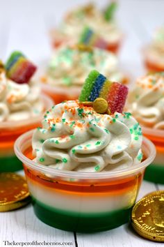 cupcakes with white frosting and rainbow decorations