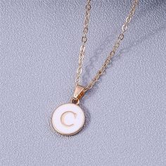 Add a personalized touch to your look with our YourLetter White Enamel Circle Necklace. Crafted with a white enamel background and gold color detailing, the necklace comes with a choice of single letter pendant. A great way to show off your initials or those of someone you love. Gold Initial Pendant Necklace With Letter Print, White Minimalist Initial Necklace As Gift, Minimalist White Jewelry With Initial Pendant, White Initial Pendant Necklace With Monogram, White Monogram Initial Pendant Necklace, White Monogram Initial Necklace, White Minimalist Initial Pendant Necklace, Personalized Gold Enamel Charm Necklace, Personalized White Initial Pendant Necklace