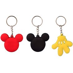 three mickey mouse keychains are shown in different colors and shapes, one is yellow, the other is red