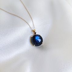 This stunning pendant is set in 14k Solid Yellow Gold with Natural Labradorite having a beautiful blue sheen. It is an unique gemstone pendant for nearly every occasion and is completely hassle-free jewelry. ITEM DETAILS: * GEM: Labradorite  * GEM Size: 15x15mm * GEM Shape: Round * Gem Weight: 11.55 carats * Gold Purity: 14KT  * Gold Weight: 0.77 gram * Total Weight of the Pendant: 3.08 gram The Gold purity is guaranteed and it comes with an authentic 14KT gold hallmark. Since my items are handmade, they are absolutely nickel and lead free. CUSTOMIZATION: * Gemstone customization is available and it can be substituted with a gem of your choice. Kindly message me for the same. PACKAGING * The Pendant comes with layers of safe and secure wrapping along with a Free handmade jewelry box with e Blue Gemstone Necklace In Labradorite, Blue Labradorite Gemstone Necklace, Labradorite Blue Necklace As Gift, Blue Labradorite Gemstone Jewelry, Blue Round Labradorite Jewelry, Yellow Gold Labradorite Round Jewelry, Yellow Gold Labradorite Necklace For Gift, Round Sapphire Cabochon Necklaces, Elegant Labradorite Necklace For Gift