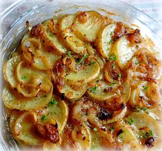 a glass bowl filled with cooked onions on top of a white and red table cloth