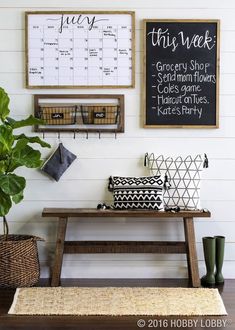 a wooden bench sitting next to a potted plant on top of a hard wood floor