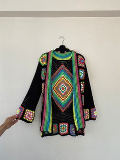 in stock! Granny square black boho style patchwork cardigan is combined with inspiration from the rainbow. :) The yarn used in the cardigan is cotton. It will be a unique gift to have a wonderful product for your loved ones for their birthdays and special occasions! Be the sparkle of your festivals and parties! Cardigan Sizes Width 105 cm / 41.3 inch Height 70 cm / 27.5 inches Model Size: 178 cm / 5 Feet 10.79 Inches / 63 kg - 138 lb. washing information It can be washed in the hand wash program Bohemian Multicolor Sweater For Beach, Bohemian Multicolor Beach Sweater, Multicolor Bohemian Beach Sweater, Multicolor Hippie Festival Sweater, Black Bohemian Sweater With Crochet Details, Black Bohemian Crochet Sweater, Handmade Black Bohemian Outerwear, Bohemian Black Patchwork Outerwear, Black Bohemian Patchwork Outerwear