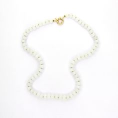 This 18.5" necklace features hand-knotted white Jade gemstones strung with lime green silk thread. Finished with a gold-filled clasp, it offers the versatility of adding charms for a personalized touch and looks great layered or worn alone. White Jade is believed to promote love, luck, and peace. Everyday White Single Strand Beaded Necklace, Everyday White Single Strand Necklace, White Round Beads Crystal Necklace Minimalist Style, Minimalist White Crystal Necklaces With Round Beads, Minimalist White Crystal Necklace With Round Beads, White Hand-strung Rondelle Necklace, Minimalist White Gemstone Beaded Necklaces, White Minimalist Beaded Gemstone Necklace, White Hand-strung Crystal Necklace For Gift