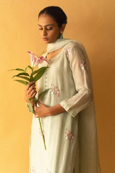 Ice green kurta with resham, zari floral embroidery and potli button detailing. Paired with pant and dupatta.
Components: 3
Pattern: Embroidered
Type Of Work: Floral
Neckline: Round
Sleeve Type: Three quarter
Fabric: Kurta: cotton chanderi, Dupatta: kota silk, Pant: bamboo cotton
Color: Green
Other Details: 
Cutwork border detailing
Attached lining
Occasion: Puja - Aza Fashions Potli Button, Chanderi Dupatta, Kurta Cotton, Silk Pant, Types Of Work, Kurta With Pants, Cut Work, Pant Set, Set For Women