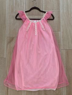 "Here we have an adorable bubblegum pink Designer nightgown from the 1960's. Two layers of fabric with the outer fabric a pretty hot pink chiffon. Very pretty white crisscross lacing at bodice. Sheer flutter sleeves. White interior lining. Size: Small Measurements while laying flat: Bust 18.5\" Waist 20\" Hips 24\" Length 34\" (Model shown is 6 feet tall and wears a size 6/8 dress and 34DD bust for sizing) This gown is in good vintage condition however there is a very tiny hole in the interior l Cute Summer Party Sleepwear, Pink Summer Dress For Sleepover, Pink Summer Dresses For Sleepover, Cute Sleeveless Sleepwear For Party, Pink Ruffle Dress For Bedtime, Beach Nightgown With Ruffles For Spring, Spring Beach Nightgown With Ruffles, Pink Spring Nightgown For Sleep, Pink Summer Nightgown For Bedtime