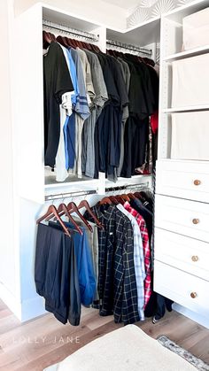 an organized closet with clothes hanging on the rails and drawers, along with a rug