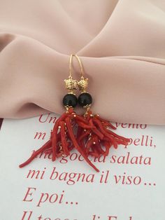 Statement earrings made of: - Natural Coral branches, red color; - Faceted Onyx stones (8 mm), black color; - Gold plated 925 Sterling Silver hookswith little turtle. Lenght : 6 cm / 2,36 inches * SHIPPING * Your order will be shipped within 1-3 business days from your purchase. You can choose between 2 shipping methods: STANDARD MAIL (NOT TRACEABLE) It is a cheap and fast shipping method, but NOT TRACEABLE. Chapeau Atelier is not responsible for any postal disruptions, delays or losses. REGISTE Elegant Red Coral Dangle Earrings, Elegant Red Coral Drop Earrings, Black Natural Stones Earrings For Gift, Black Earrings With Natural Stones For Gift, Black Earrings With Natural Stones, Elegant Red Coral Jewelry With Matching Earrings, Elegant Red Coral Earrings, Elegant Red Coral Jewelry With Natural Stones, Red Coral Dangle Jewelry As Gift