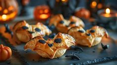 some pumpkins with faces on them and candles in the background