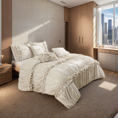 a bedroom with a bed, dresser and window overlooking the cityscape in the background