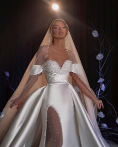 a woman in a white wedding gown and veil