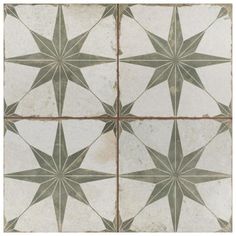 an old tile floor with four pointed stars on the bottom and one star in the middle