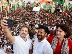 two men and a woman taking a selfie in front of a large group of people