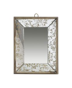 an ornate mirror hanging on a rope with a white and gold border around the frame