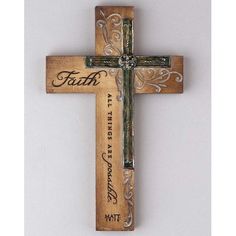 a wooden cross with the word faith on it's side and an ornate design