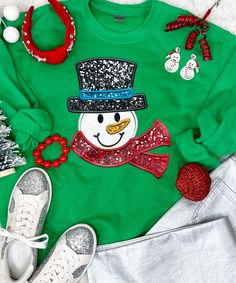 Introducing our "Faux Sequin Snowman Graphic Shirt" – a whimsical and festive addition to your winter wardrobe. This shirt features a charming snowman graphic adorned with faux sequins, providing a sparkling appearance without the actual texture of real sequins.
Available in short sleeves, long sleeves, or as a cozy sweatshirt, our "Faux Sequin Snowman Graphic Shirt" offers versatility for various occasions and weather. The graphic sequins are a graphic representation, ensuring a smooth an Winter Glitter Long Sleeve Tops, Glitter Long Sleeve Winter Tops, Glitter Long Sleeve Tops For Winter, Long Sleeve Glitter Top For Winter, Long Sleeve Glitter Tops For Winter, Festive Long Sleeve Glitter Tops, Christmas Sequin Top For Festive Occasions, Casual Winter Party T-shirt, Fall Holiday Tops With Sequins