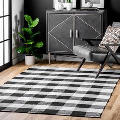 a black and white area rug in a living room with a zebra print accent chair