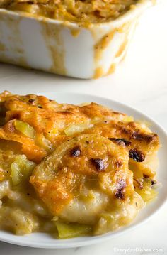 a casserole dish on a white plate next to the casserole dish