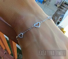 "Cubic Zirconia Heart Dainty SOLID sterling stamped 925 silver Tarnish free Bracelet 7 inch up to 8inch This is a 7\" and goes up to 8\" (Adjustable) - Prong setting, with 80 clear RoundCubic Zirconia bracelet. The thickness of this bracelet is 2mm and the height 7.2 This is SOLID Sterling silver with Rhodium plating which makes this Tarnish free! Please follow care instructions. Any rings with stones, regardless where you purchase, must be removed when washing hands or using hair gels or hair c Dainty Silver Bracelets For Promise, Dainty Silver Promise Bracelets, Dainty Sterling Silver Heart Bracelet, Dainty Heart-shaped Sterling Silver Bracelet, Silver Cubic Zirconia Heart Bracelet For Valentine's Day, Heart Cut Sterling Silver Bracelet As Gift, Dainty Sterling Silver Heart Bracelet As Gift, Dainty Sterling Silver Heart Bracelet For Gift, Dainty Sterling Silver Bracelets For Valentine's Day