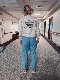 a woman wearing a sweatshirt that says, i birthday parties every day in front of her